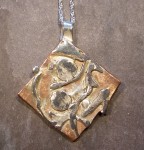 Thick copper pendant with silver slices